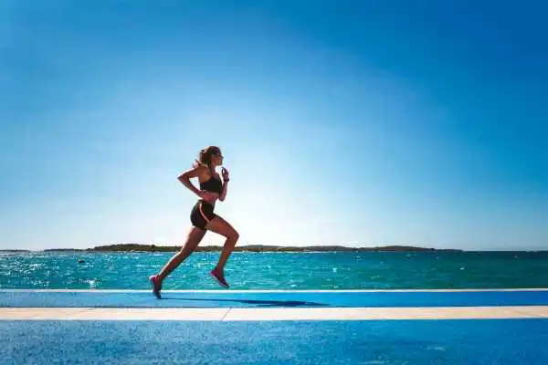 Woman running showing strong leg muscle Hackney